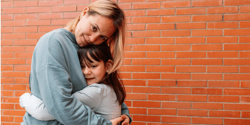 Image of woman hugging a child for blog: How emotion outperforms urgency in December appeals