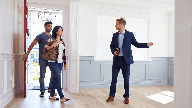 Realtor showing a house to a couple