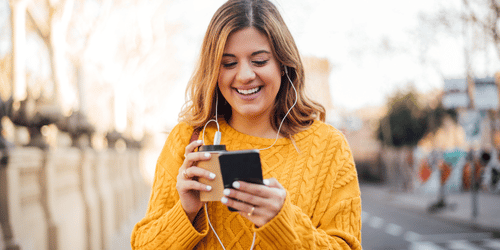 Woman looking at her phone potentially at an email from a nonprofit