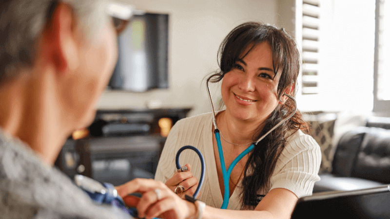 Nurse listening to heartbeat of patient