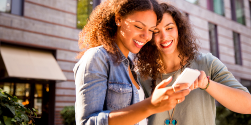 two women looking at phone