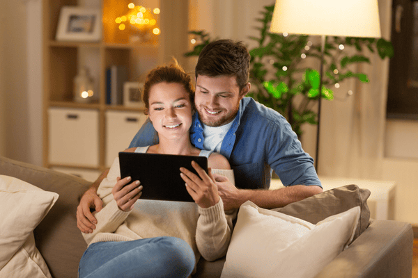 Image of a couple looking at a tablet reading a thank you email from a donation to a nonprofit