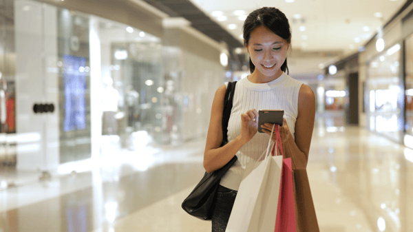 woman-shopping-looking-at-phone