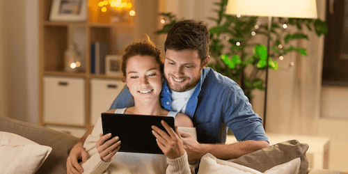 Image of a couple looking at a tablet reading a thank you email from a donation to a nonprofit